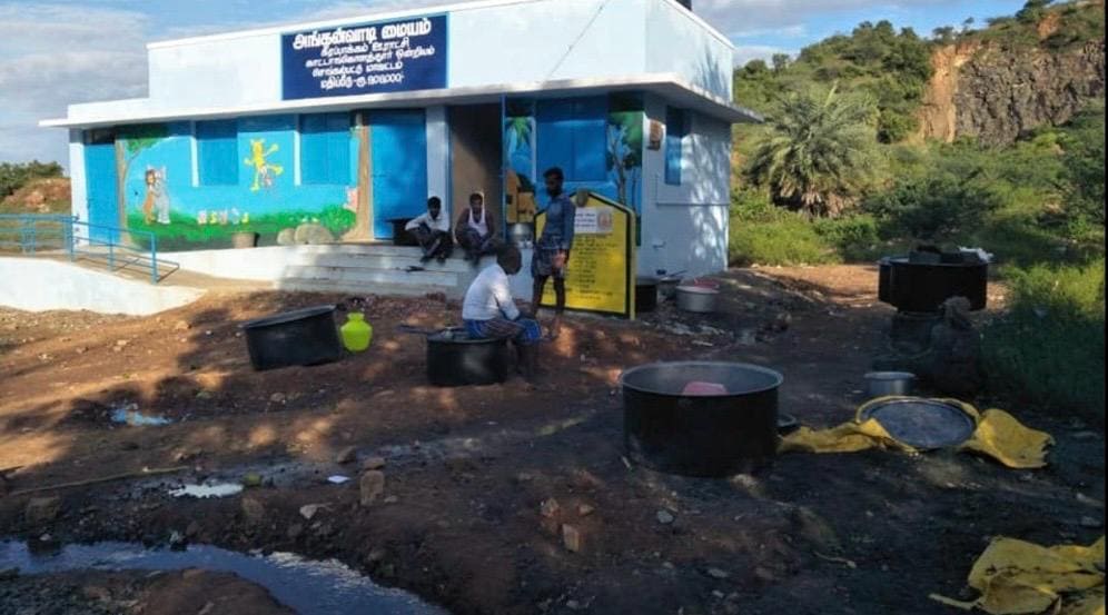 Volunteers distributing food kits to poor families